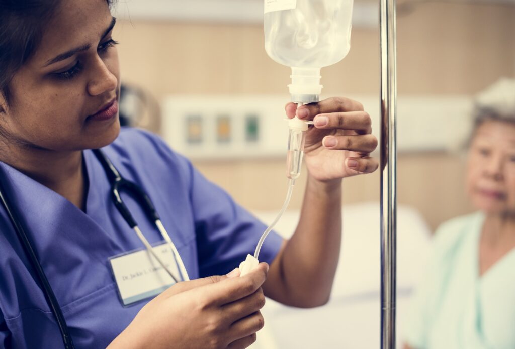 Nurse taking care of an old patient